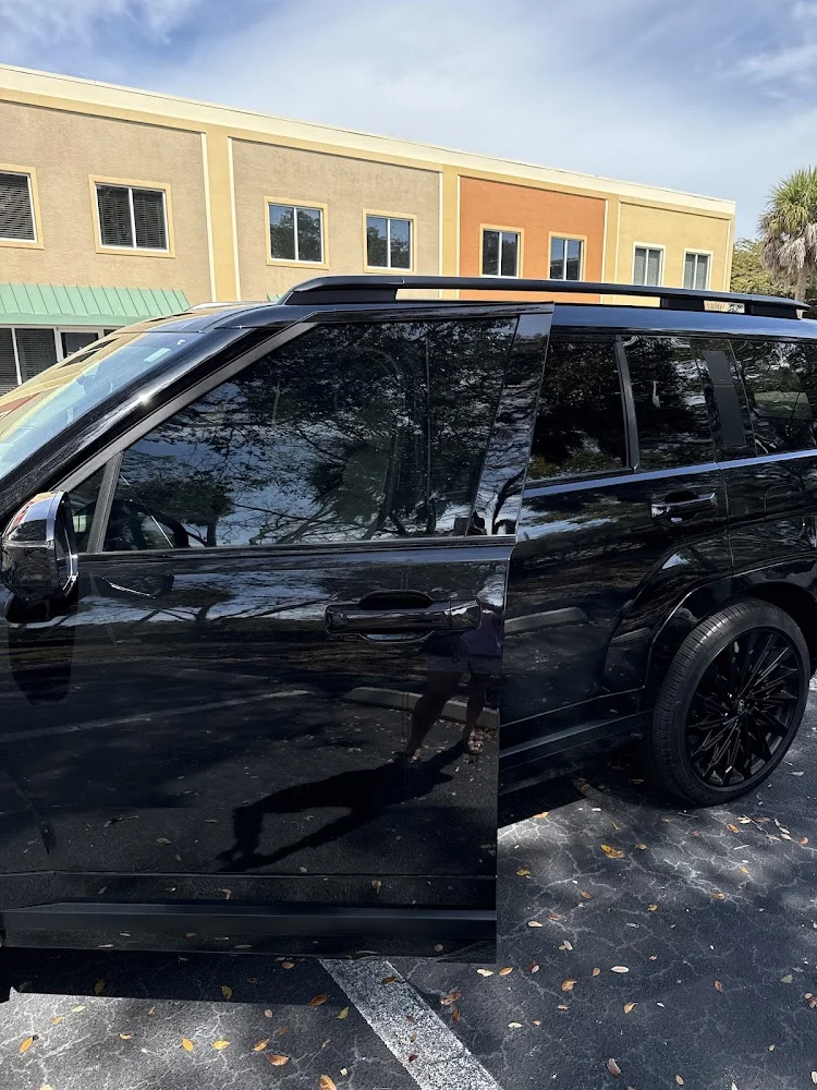 Dark SUV with freshly tinted side windows, photographed by Google reviewer Dawna Gold