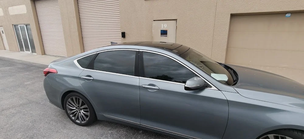 Gray sedan with tinted windows outside the shop, photographed by Google reviewer Jamal Rose