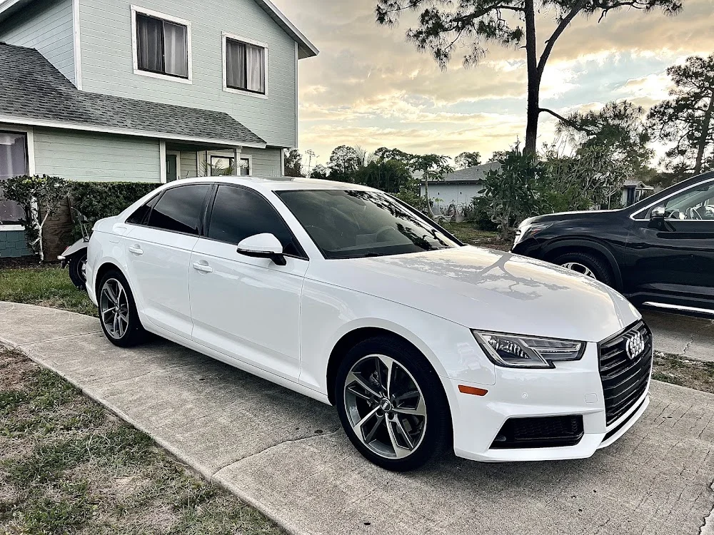 White Audi A4 with dark tinted windows, photographed by Google reviewer Jeremy Rosario