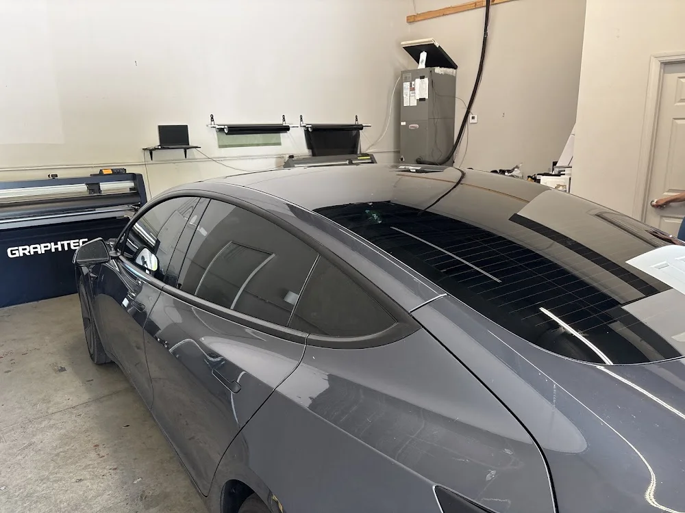 Gray Tesla Model 3 with tinted glass inside the shop, photographed by Google reviewer Matthew Gagnon