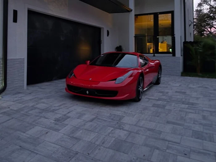 Red Ferrari 458 outside a Naples home after window-tint installation by Tamiami